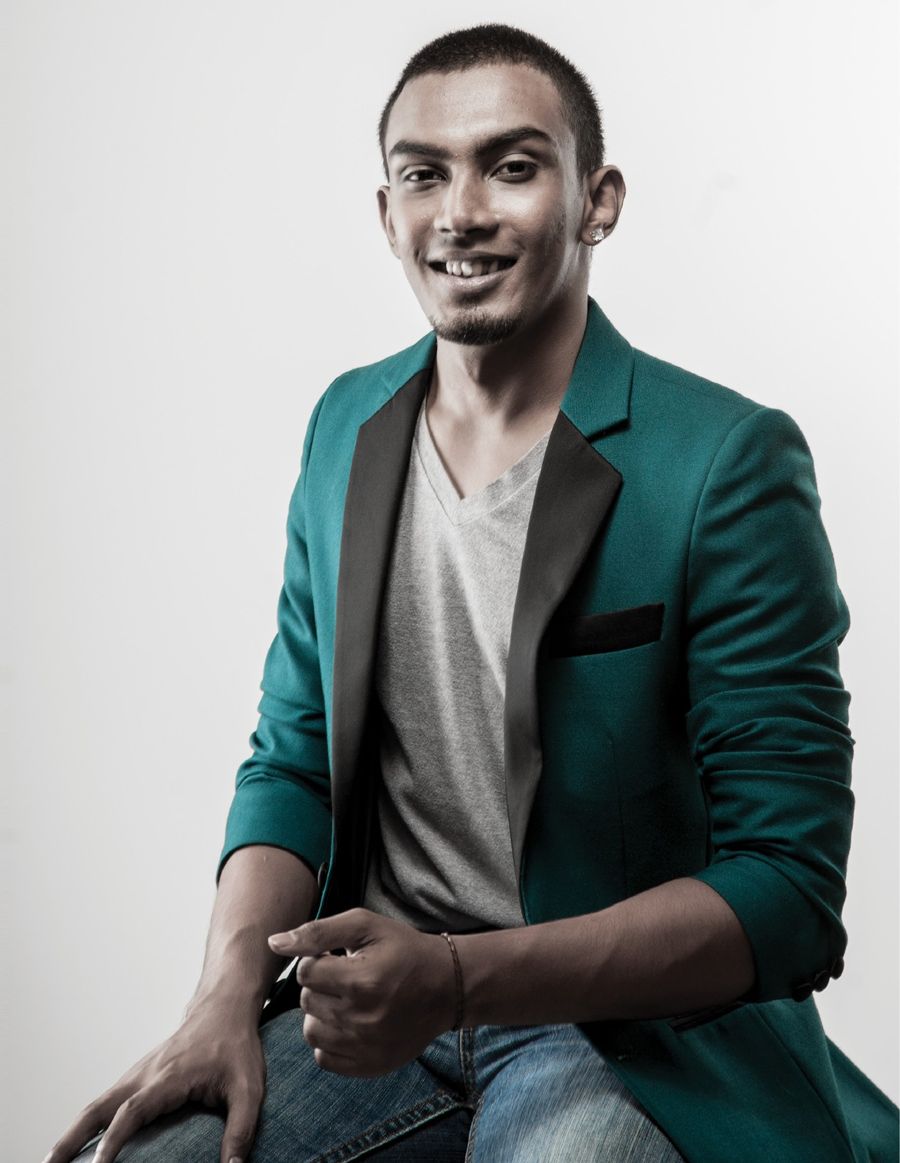Ryan De Mel smiling, seated