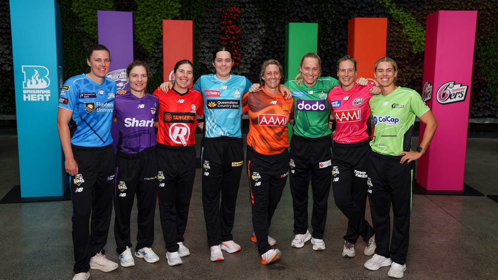 Players from all eight WBBL teams, each in their club kit, at the launch of WBBL|12 at the Sydney Botanic Gardens